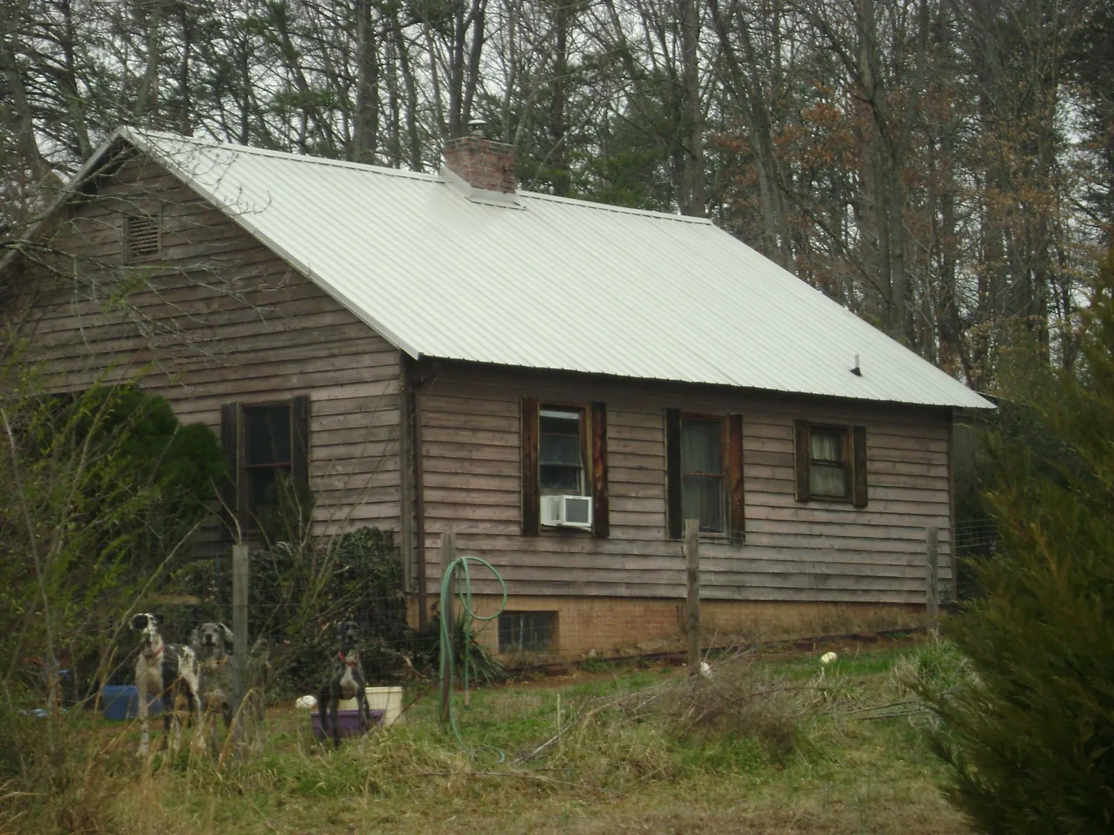 White metal roof on an old wood sided farmhouse, from a Metal Roof Installation job in Oxford